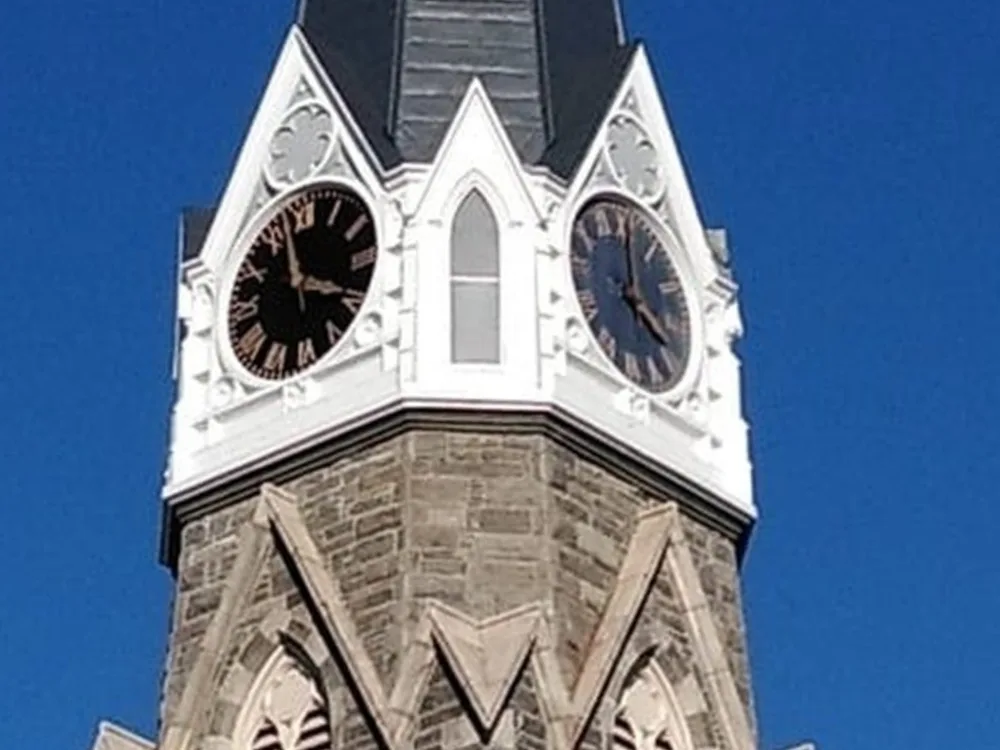 Clock tower restoration completed, with clean surfaces and renewed structure.