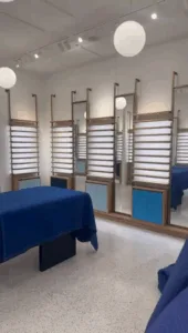 Commercial interior renovation featuring display shelving with mirrors and clean finishes.