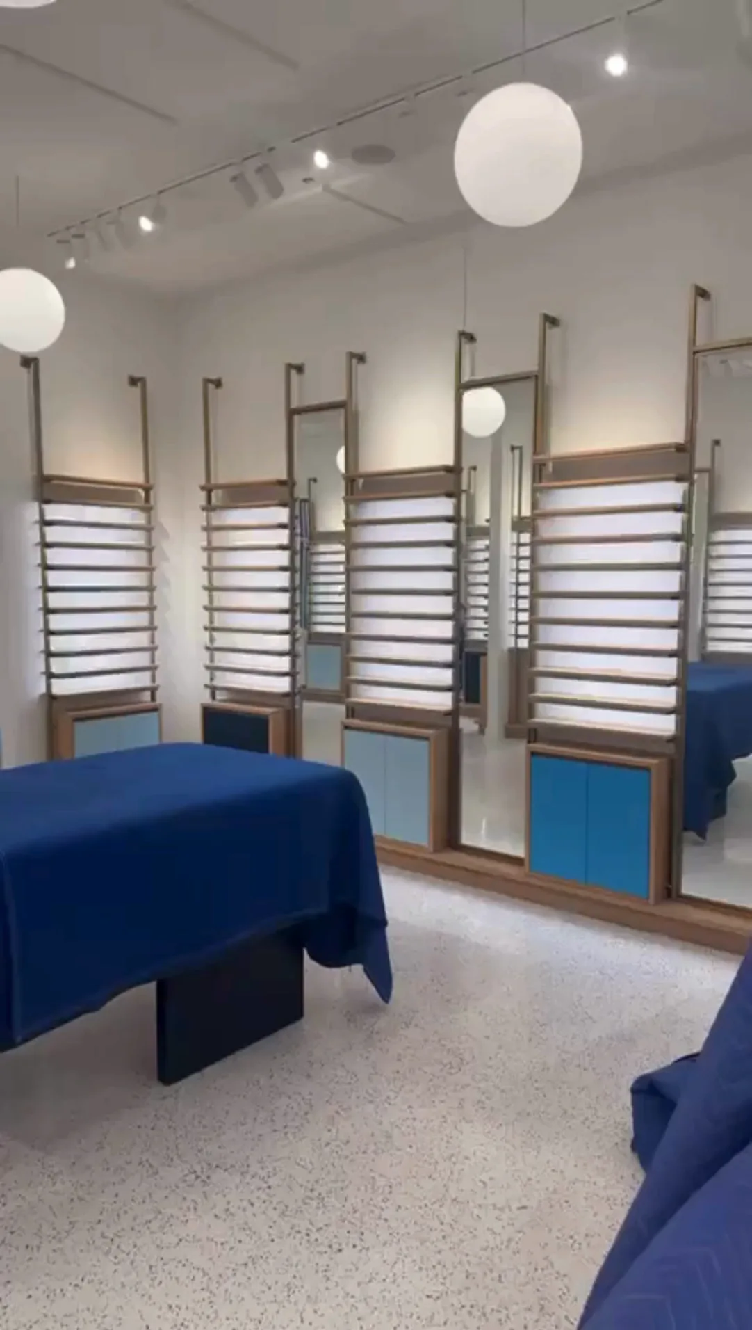 Commercial interior renovation featuring display shelving with mirrors and clean finishes.