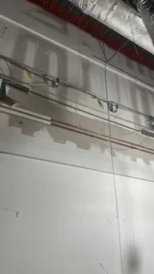 Commercial interior renovation with unfinished drywall and visible wiring.